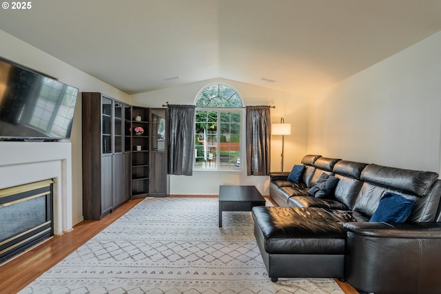 living room featuring light hardwood / wood-style floors and lofted ceiling