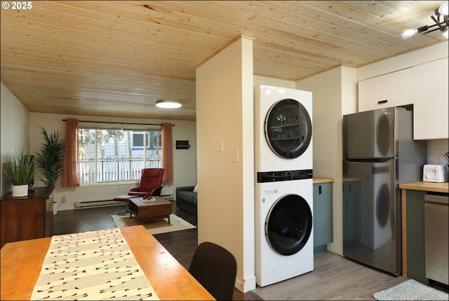 laundry area with stacked washer and dryer, a baseboard heating unit, wood ceiling, and light wood-type flooring