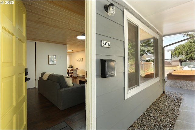 interior space with dark hardwood / wood-style floors and wooden ceiling