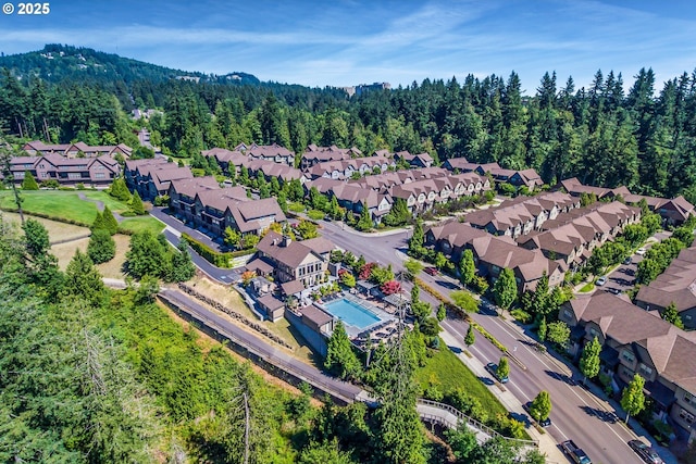 birds eye view of property featuring a residential view and a view of trees