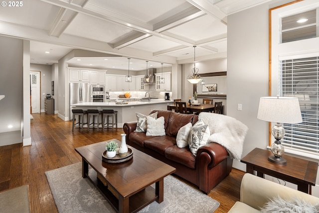 living room with baseboards, coffered ceiling, dark wood-type flooring, beam ceiling, and recessed lighting