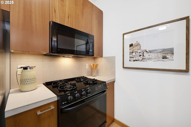 kitchen with black appliances and decorative backsplash