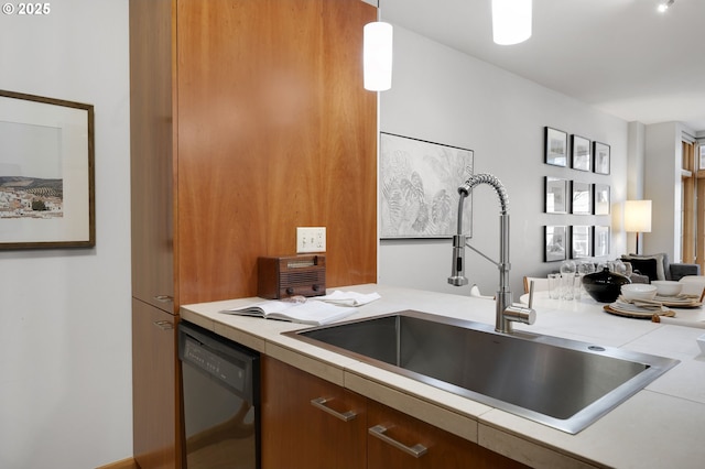 kitchen featuring sink, pendant lighting, and dishwasher