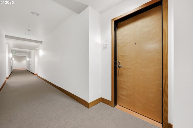 corridor featuring light colored carpet