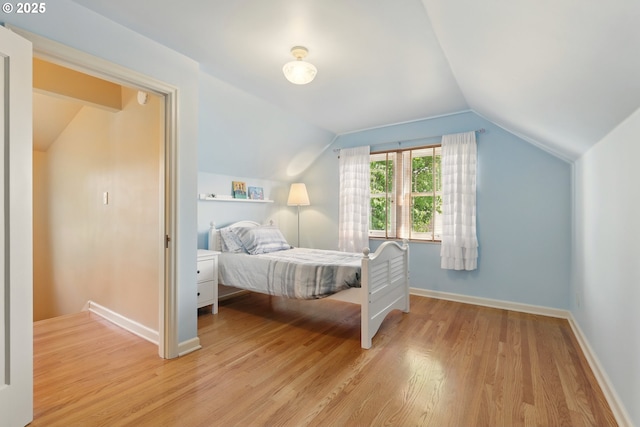 2804 NE 46th Ave, Portland, OR 97213 - bedroom with wood finished floors, vaulted ceiling, and baseboards