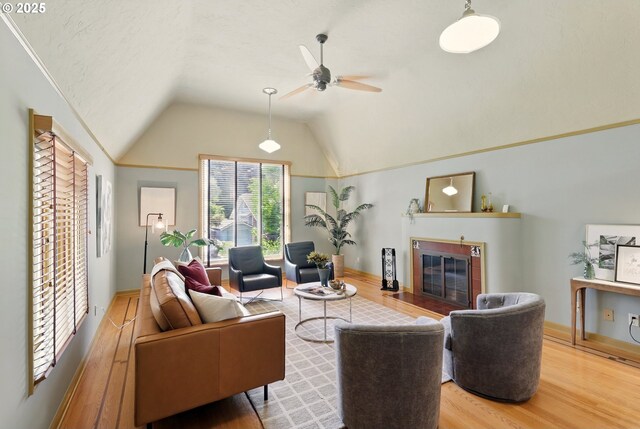 2804 NE 46th Ave, Portland, OR 97213 - living room featuring a tile fireplace, wood finished floors, vaulted ceiling, and ceiling fan