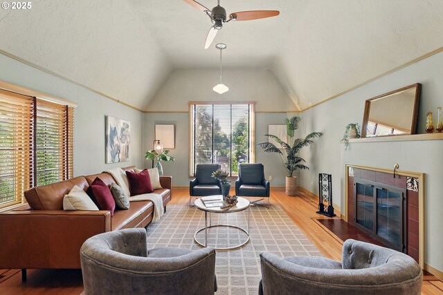 2804 NE 46th Ave, Portland, OR 97213 - living room with a tiled fireplace, wood finished floors, vaulted ceiling, a ceiling fan, and baseboards