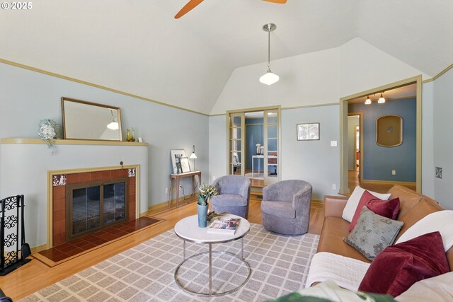 2804 NE 46th Ave, Portland, OR 97213 - living room with ceiling fan, wood finished floors, a tiled fireplace, high vaulted ceiling, and baseboards