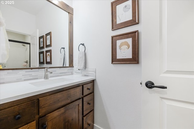 bathroom featuring vanity and backsplash