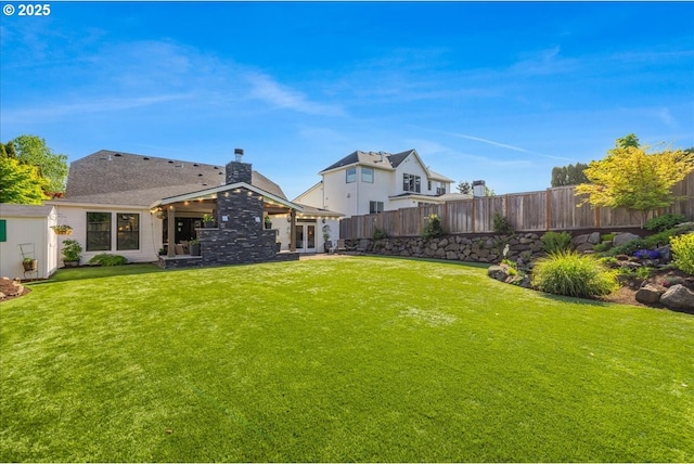 view of yard with fence and french doors