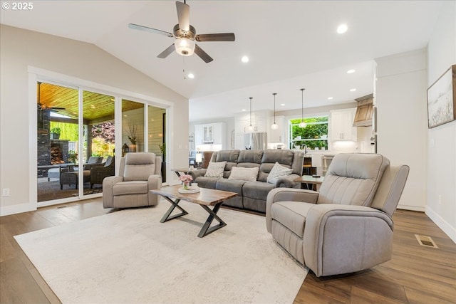 living room with ceiling fan, recessed lighting, wood finished floors, lofted ceiling, and visible vents