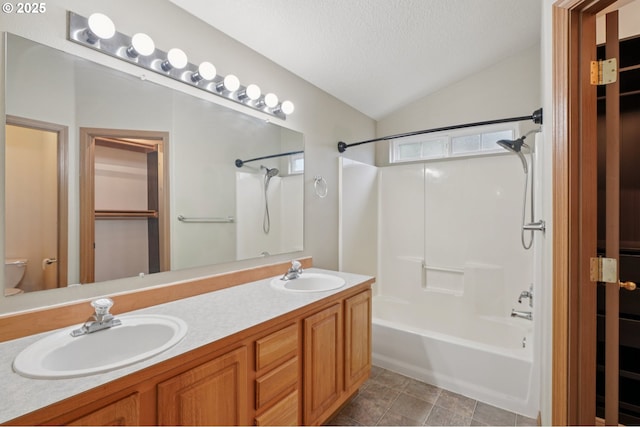 1041 40th St, Washougal, WA 98671 - bathroom featuring vaulted ceiling, shower / bath combination, double vanity, and a textured ceiling