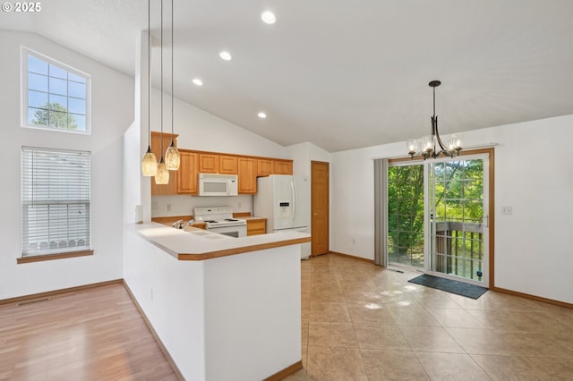 1041 40th St, Washougal, WA 98671 - kitchen featuring white appliances, a chandelier, vaulted ceiling, light countertops, and recessed lighting