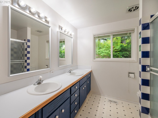 2830 Capital Dr, Eugene, OR 97403 - full bathroom with double vanity, an enclosed shower, and tile patterned floors