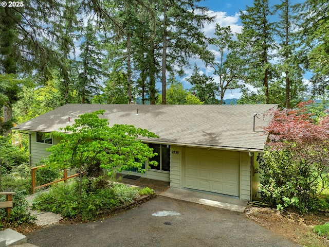 2830 Capital Dr, Eugene, OR 97403 - view of front facade featuring driveway, a shingled roof, and a garage