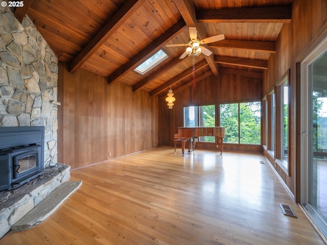 2830 Capital Dr, Eugene, OR 97403 - unfurnished living room featuring hardwood / wood-style flooring, a skylight, a ceiling fan, wood walls, and wood ceiling