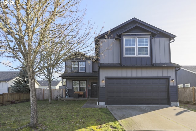 traditional-style house with a garage, fence, concrete driveway, a front lawn, and board and batten siding