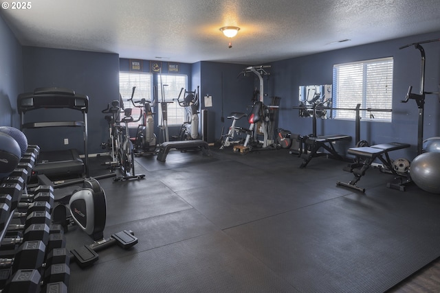 exercise room featuring a textured ceiling