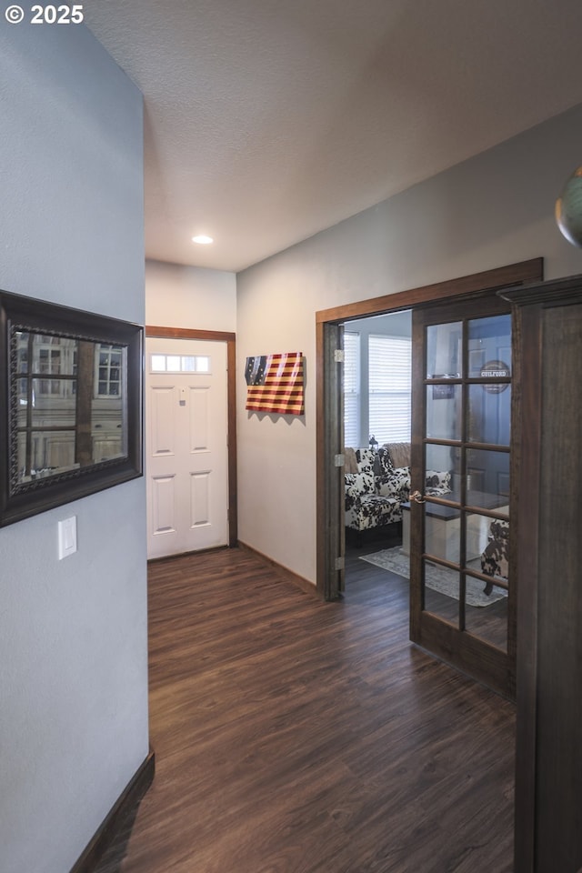 entrance foyer with baseboards and dark wood-style flooring