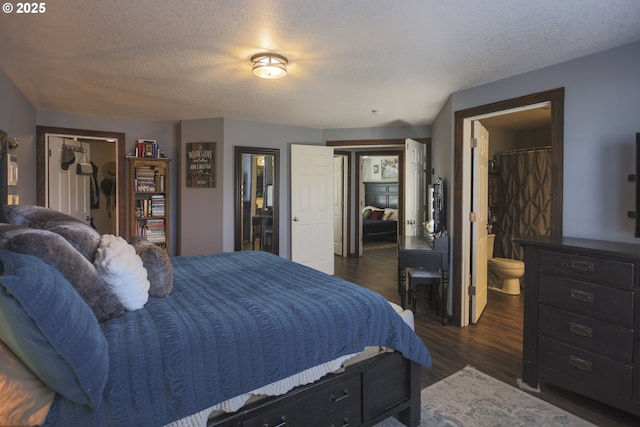 bedroom with a textured ceiling and dark wood-type flooring