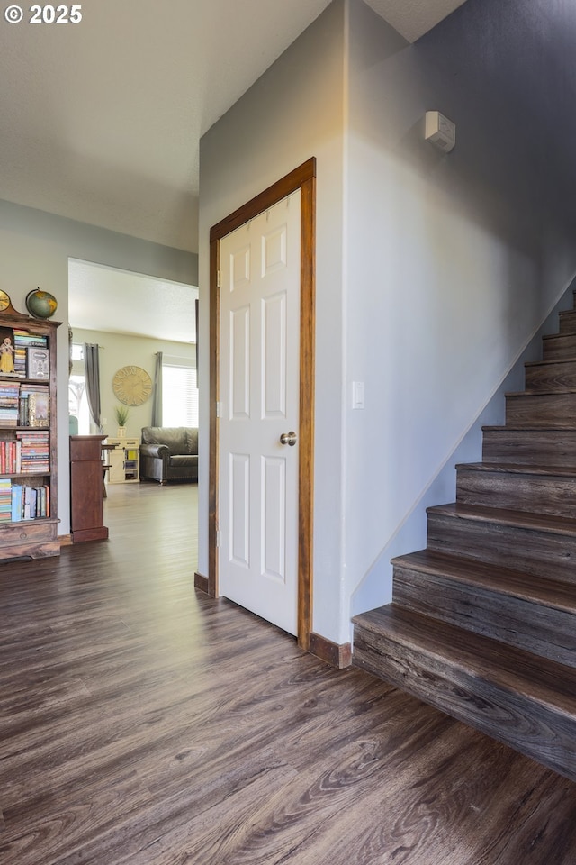 stairway featuring baseboards and wood finished floors