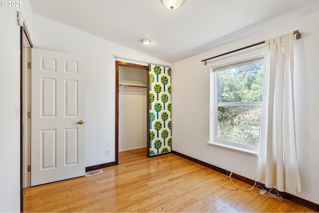 9341 N Pier Park Pl, Portland, OR 97203 - unfurnished bedroom featuring vaulted ceiling, light wood-type flooring, and a closet
