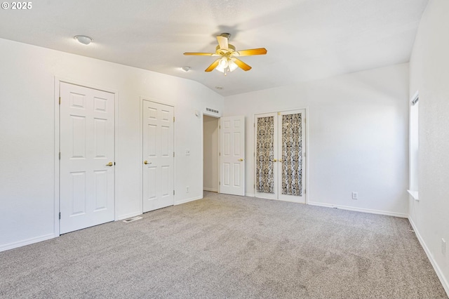 9341 N Pier Park Pl, Portland, OR 97203 - unfurnished bedroom featuring carpet flooring, multiple closets, ceiling fan, and vaulted ceiling
