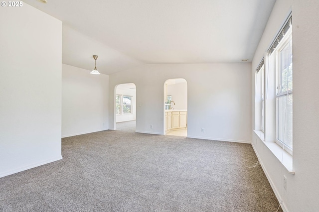 9341 N Pier Park Pl, Portland, OR 97203 - unfurnished room with arched walkways, light carpet, and lofted ceiling