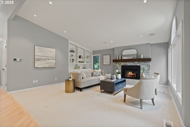 17595 Kelok Rd, Lake Oswego, OR 97034 - living area featuring vaulted ceiling, baseboards, a fireplace, built in features, and carpet flooring