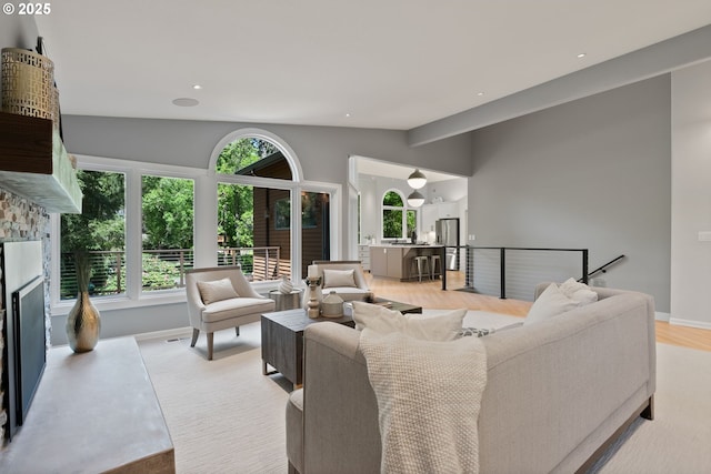 17595 Kelok Rd, Lake Oswego, OR 97034 - living room featuring plenty of natural light, lofted ceiling, a fireplace, baseboards, and recessed lighting