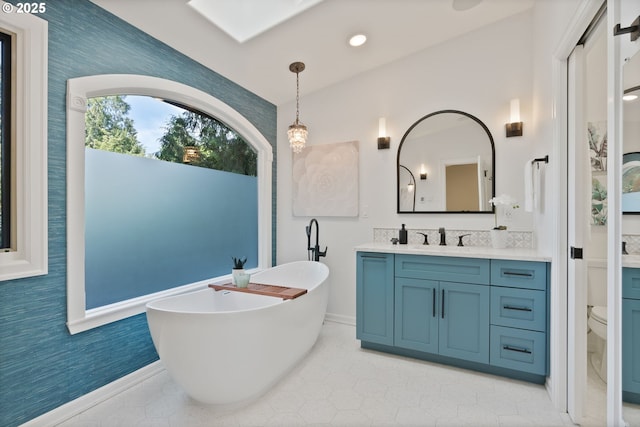 17595 Kelok Rd, Lake Oswego, OR 97034 - bathroom with vanity, a soaking tub, toilet, baseboards, and wallpapered walls