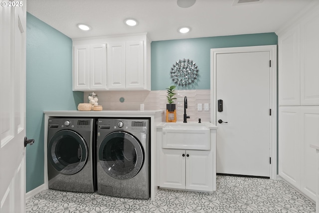 17595 Kelok Rd, Lake Oswego, OR 97034 - laundry area with independent washer and dryer, cabinet space, light tile patterned floors, and recessed lighting