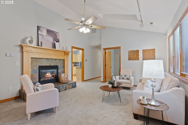 17595 Kelok Rd, Lake Oswego, OR 97034 - carpeted living room featuring rail lighting, a fireplace, baseboards, ceiling fan, and high vaulted ceiling
