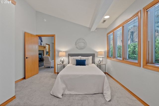 17595 Kelok Rd, Lake Oswego, OR 97034 - carpeted bedroom with baseboards, a tiled fireplace, and lofted ceiling