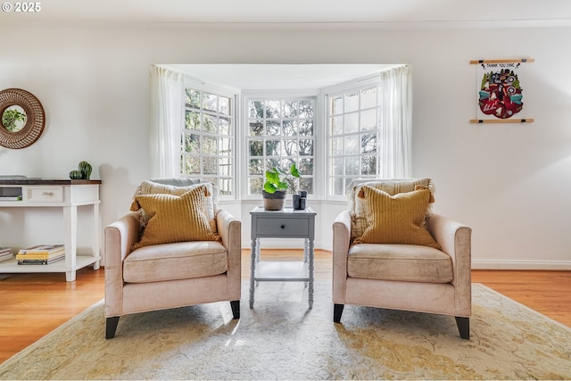 992 SW Westwood Dr, Portland, OR 97239 - sitting room featuring wood finished floors, baseboards, and crown molding
