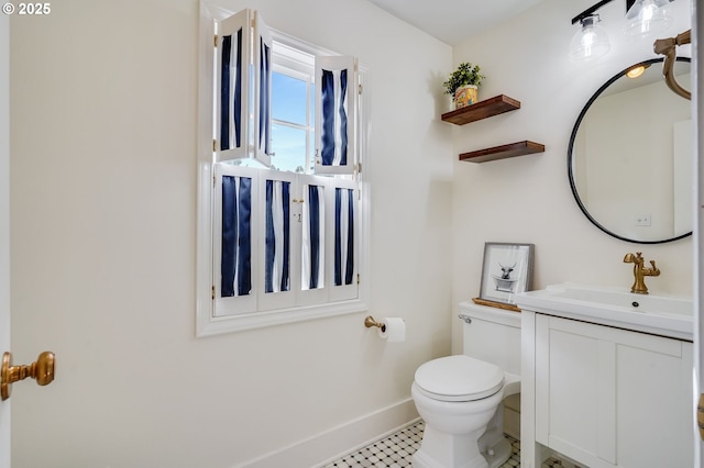 992 SW Westwood Dr, Portland, OR 97239 - bathroom with toilet, baseboards, and vanity