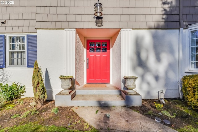 property entrance with stucco siding