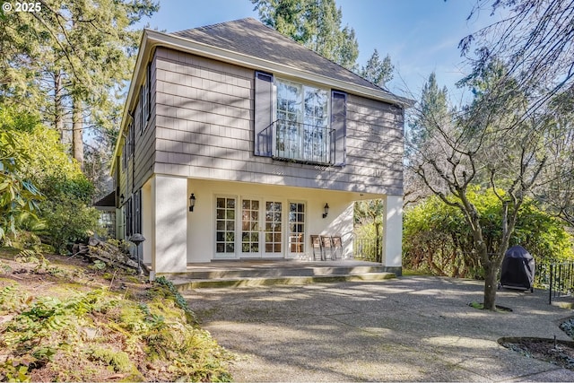 992 SW Westwood Dr, Portland, OR 97239 - back of house featuring a shingled roof, stucco siding, french doors, and a patio area