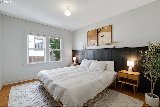 bedroom with wood finished floors and baseboards