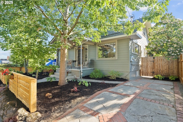view of front of house featuring fence
