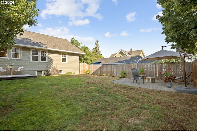 view of yard featuring a deck and a fenced backyard