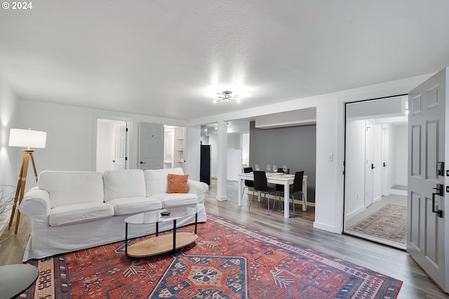living area with wood finished floors and baseboards