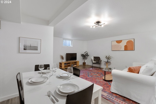 dining space with wood finished floors and baseboards