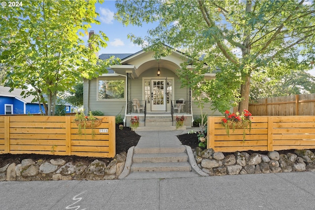 view of exterior entry featuring fence