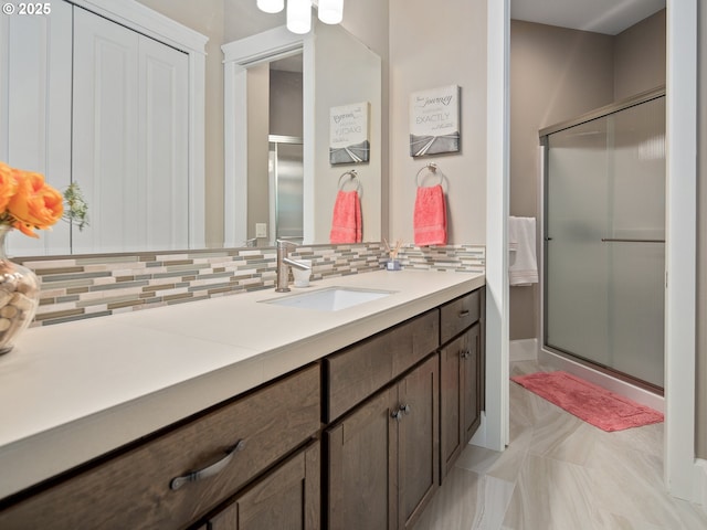 bathroom with vanity, decorative backsplash, and a stall shower