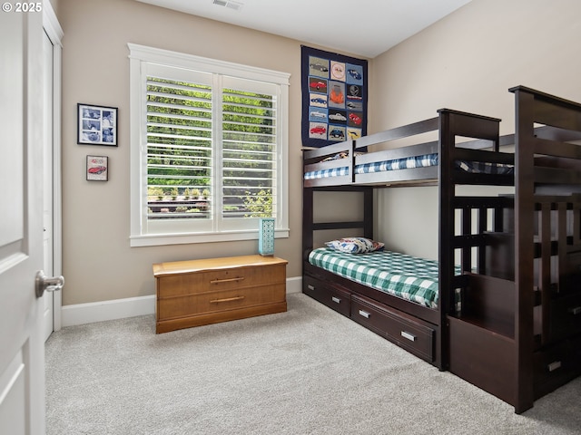 bedroom featuring baseboards, carpet flooring, and visible vents