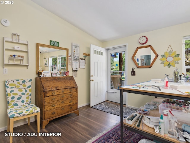 interior space with baseboards, wood finished floors, and visible vents