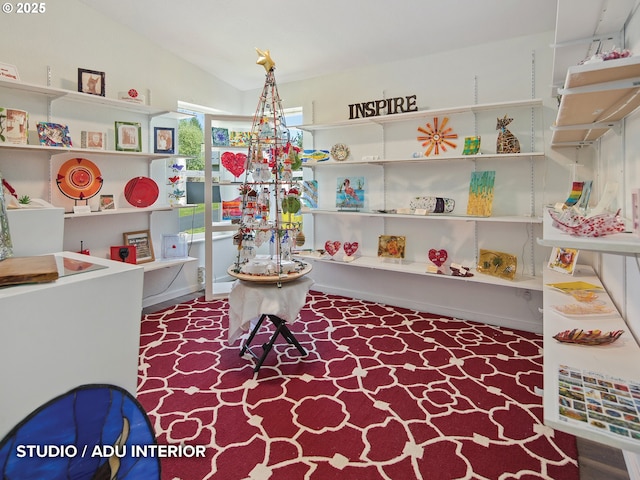 playroom with vaulted ceiling and carpet