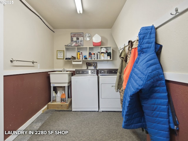 laundry room featuring washing machine and clothes dryer, laundry area, carpet floors, and baseboards