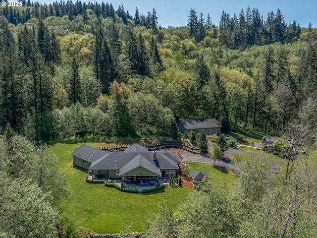 drone / aerial view featuring a forest view